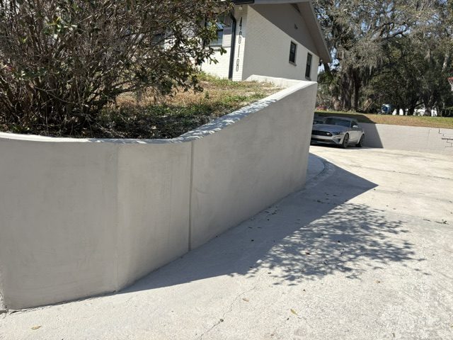 Natural stone retaining wall terracing a sloped yard
